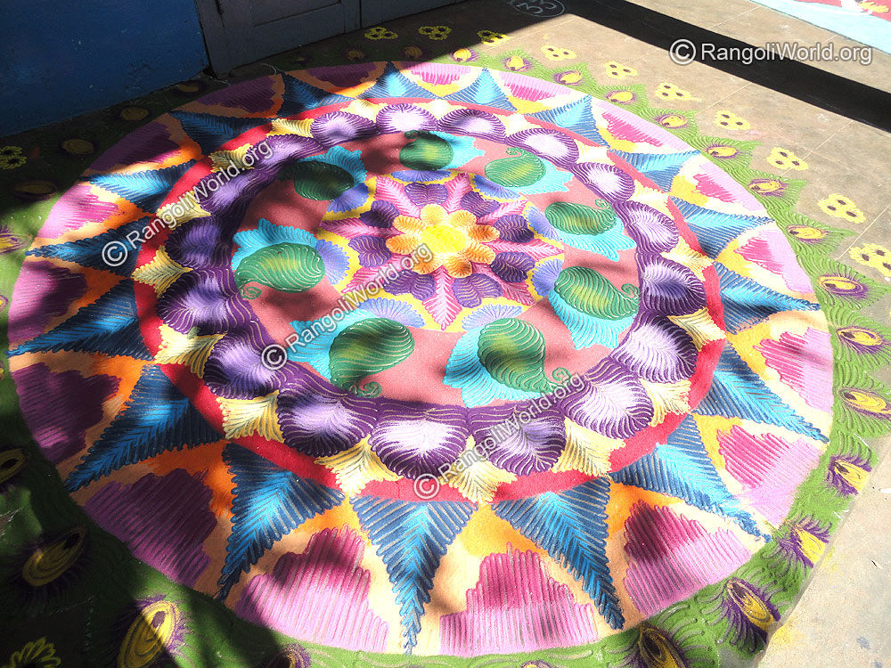 Flower Rangoli with mango, heart, half circle and triangle shapes creation 