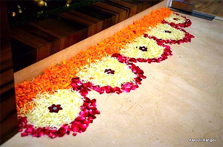 Border rangoli for onam festival using rose marigold flowers 2015
